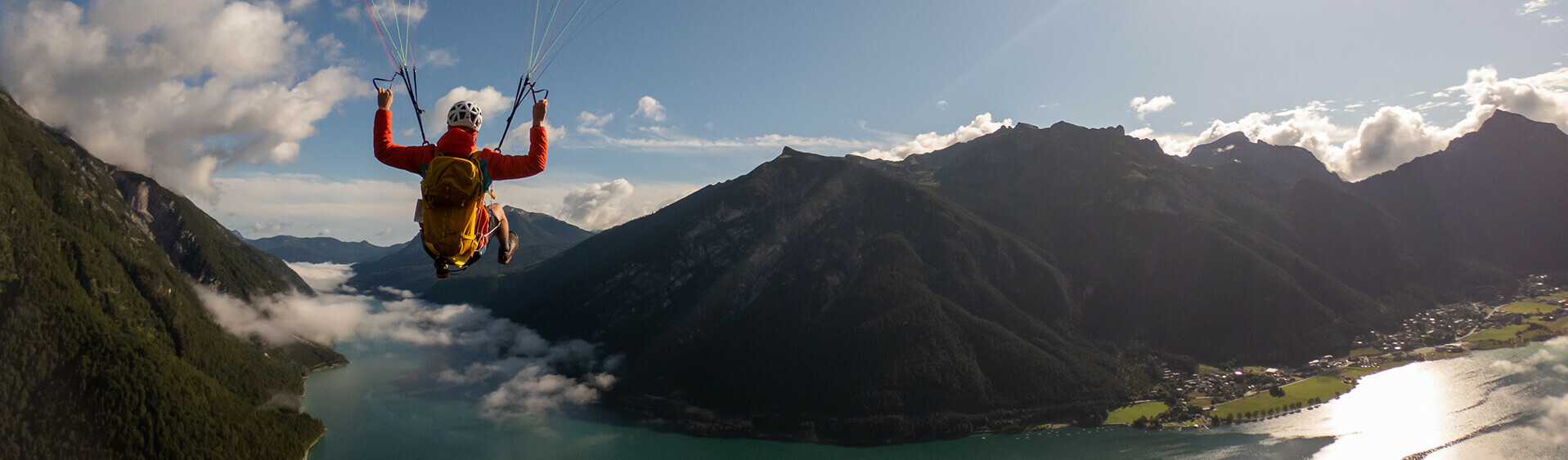Ein Flug mit dem Gleitschirm ermöglicht einen unglaublichen Ausblick auf den See und seine Berglandschaft. 