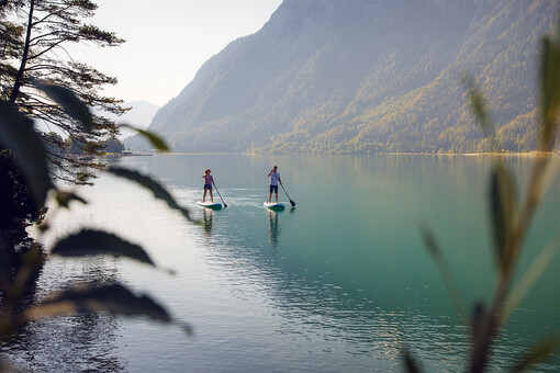 Explore Lake Achensee at a leisurely pace as you stand on a large surfboard and use a paddle to propel yourself through the water.