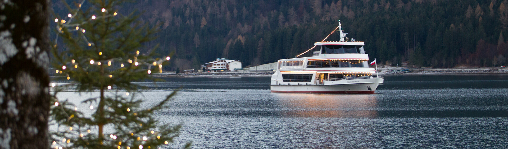 Exploring Lake Achensee in winter from on board the festively decorated ship.